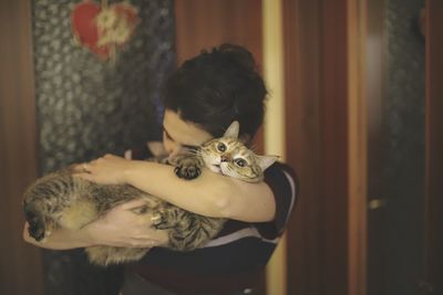 A girl hugs her pet kitten, after a long day relieves stress 