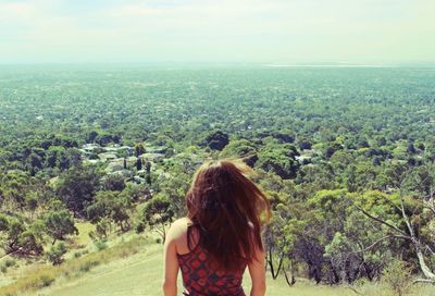 Rear view of woman standing on landscape