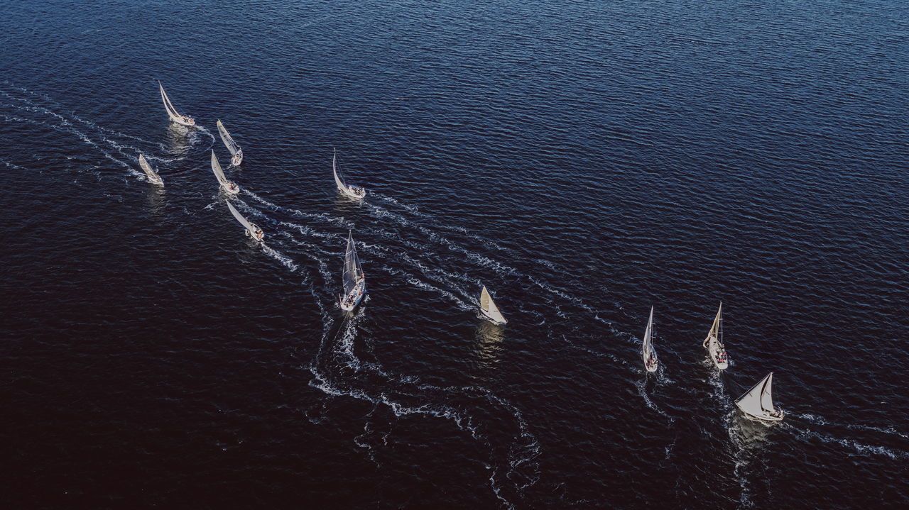 water, high angle view, day, sea, waterfront, nature, beauty in nature, tranquility, outdoors, no people, tranquil scene, non-urban scene, wake - water, motion, scenics - nature, sunlight, nautical vessel, wave pattern