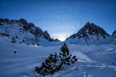 Scenic view of snowcapped mountains against clear blue sky