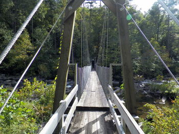 Footbridge over river in park