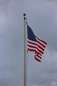 Low angle view of american flag against sky