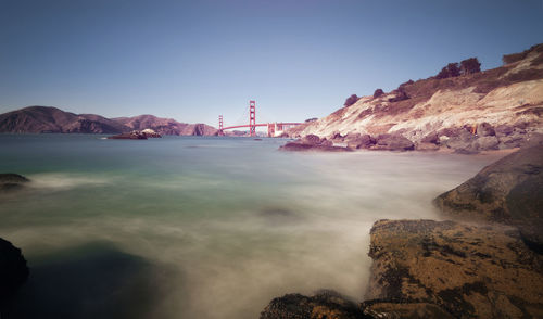 Scenic view of bay against clear sky