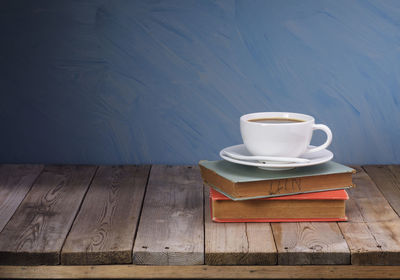 Coffee cup on table against wall