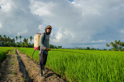 Man standing on field against sky