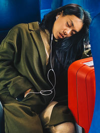 Young woman sleeping on train