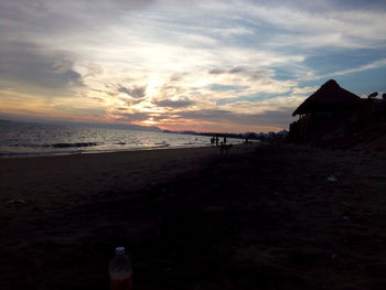 Scenic view of beach against sky during sunset