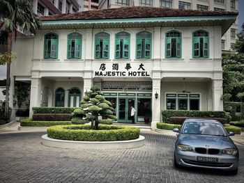 Cars on building by plants