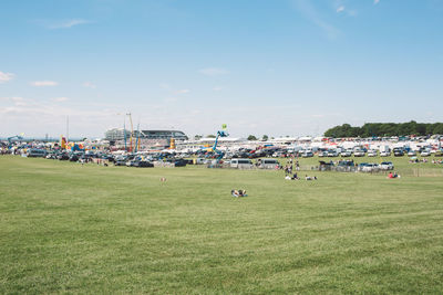 Panoramic view of people in park against sky