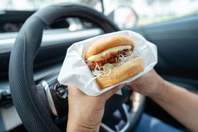 Cropped hand of woman holding food