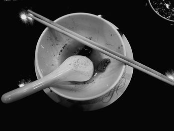 High angle view of ice cream in bowl against black background