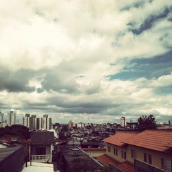 Buildings against cloudy sky