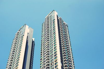 Low angle view of modern building against clear blue sky