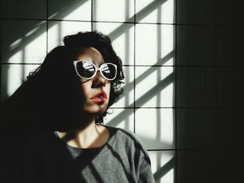 Portrait of young woman wearing sunglasses