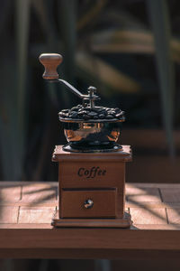 Close-up of coffee grinder on table