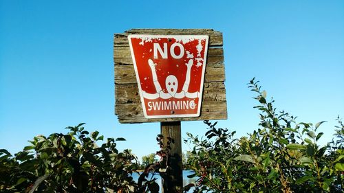 Close-up of no swimming sign