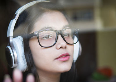 Close-up of young woman wearing eyeglasses