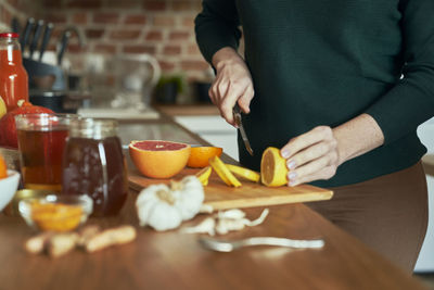 Midsection of woman preparing food on table