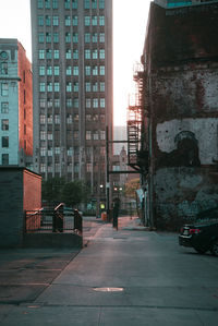 Street amidst buildings against sky in city