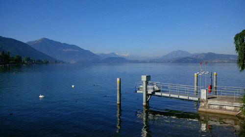 Scenic view of mountains against clear blue sky