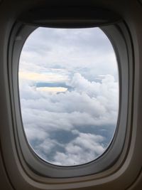 Cloudy sky seen through airplane window