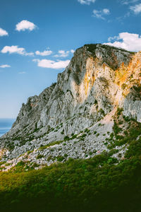 Low angle view of rock formations against sky