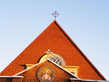 Low angle view of weather vane against clear sky