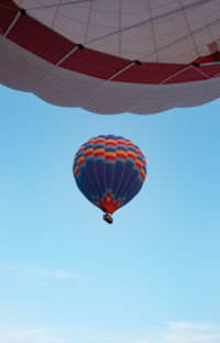 Low angle view of hot air balloon flying in sky