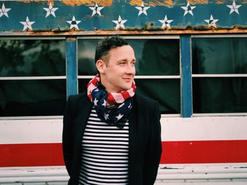 Portrait of man wearing american flag as scarf