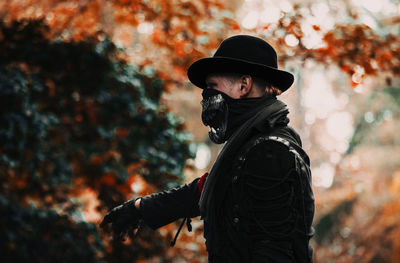 Man standing by tree during autumn