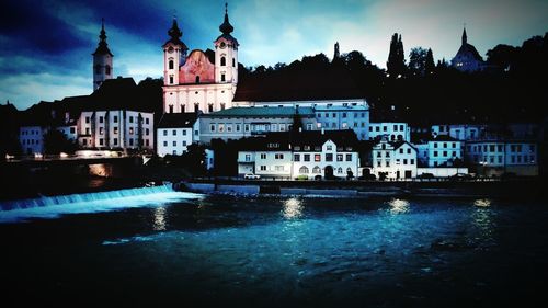 View of illuminated buildings at waterfront