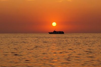 Scenic view of sea against orange sky