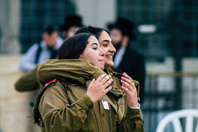 Young woman using mobile phone in city