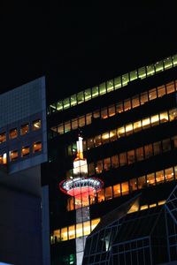 Low angle view of illuminated building against sky at night