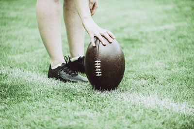 Low section of woman with ball on grass