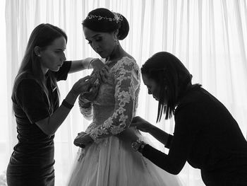 Friends standing with arms raised