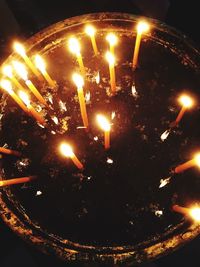 High angle view of illuminated candles in temple