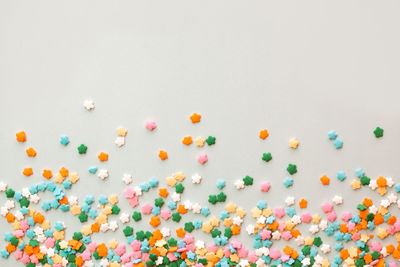 High angle view of multi colored candies against white background