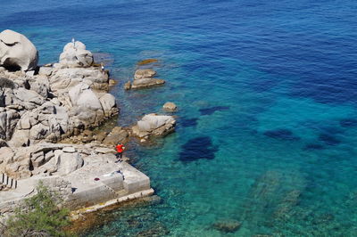 High angle view of rocks by sea