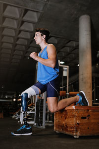 Man with artificial leg exercising in gym