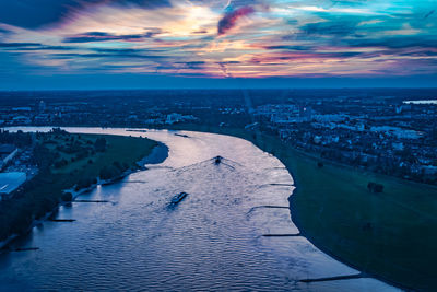 Aerial view of river against sky at sunset