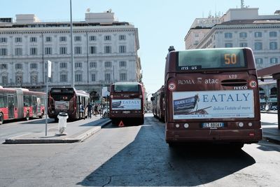 Cars on road in city against sky