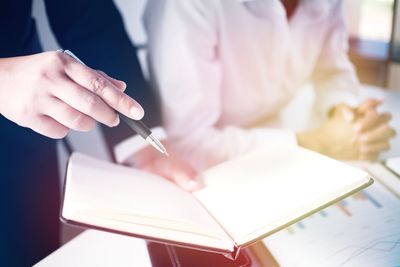 Close-up of business colleagues working in office