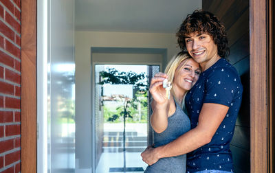 Loving couple standing at doorway