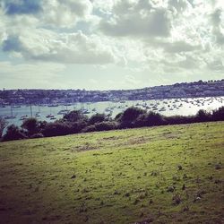 Scenic view of landscape against cloudy sky