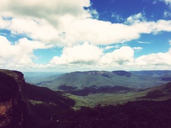 Scenic view of landscape against cloudy sky