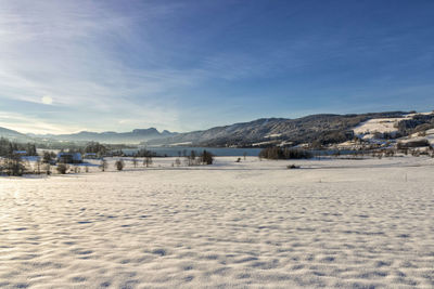 Scenic view of beach against sky during winter