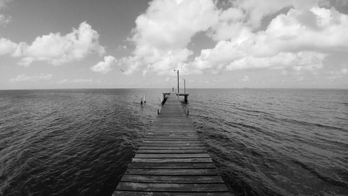 Pier over sea against sky