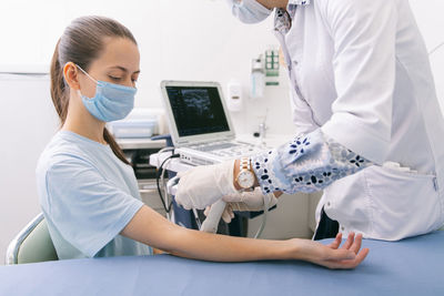 Doctor examining patient at clinic