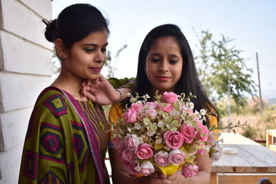 Friends looking at bouquet